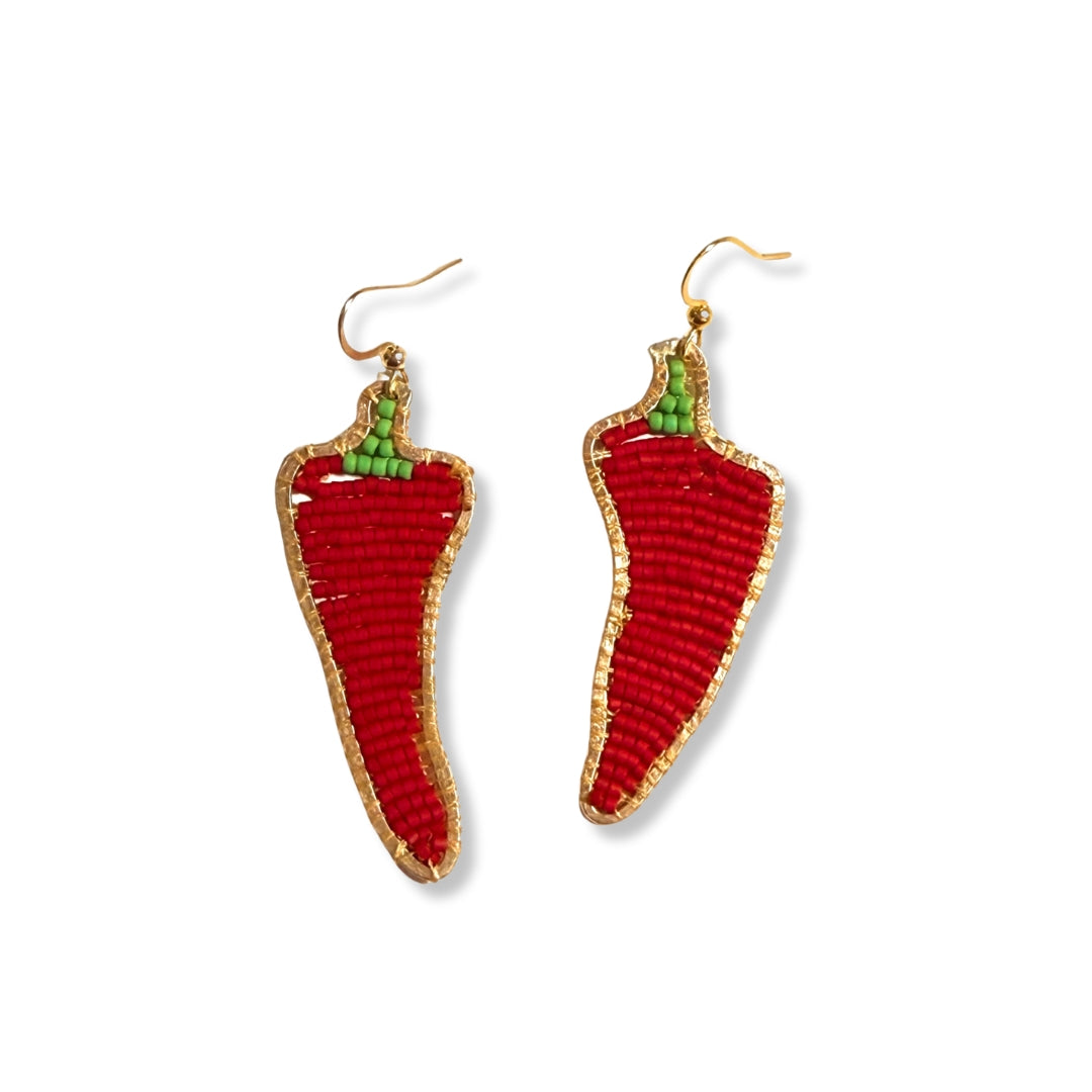 A pair of handmade earrings shaped like red peppers with gold plated fish hooks.