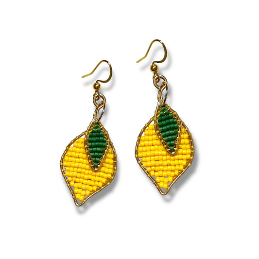Pair of yellow and green beaded lemon earrings on a white background