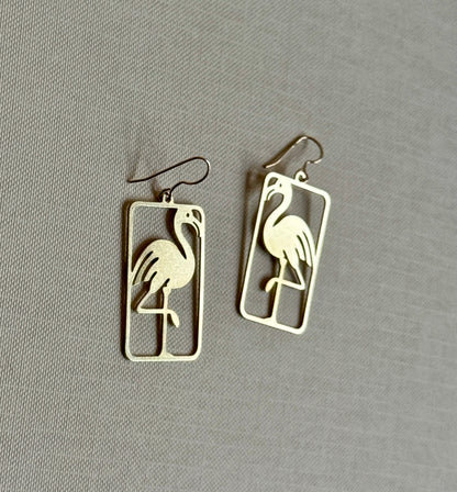 Flamingo-shaped earrings on a gray background