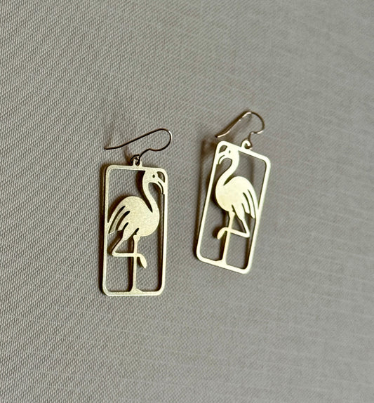 Flamingo-shaped earrings on a gray background